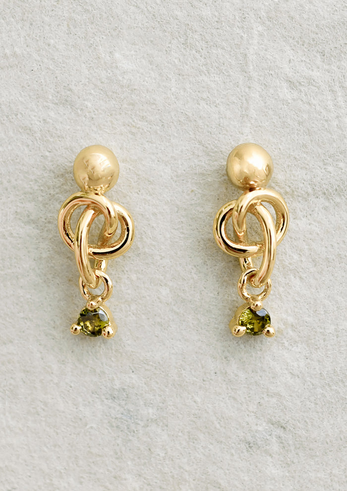 A pair of ball stud earrings with knot and green crystal.