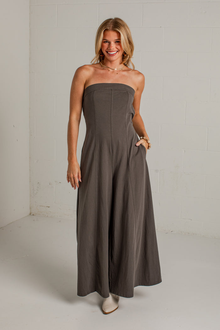 A dark gray strapless wide-leg jumpsuit with side pockets