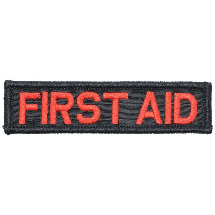 A rectangular first aid patch with red text on a black background.