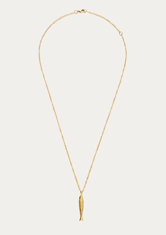 A gold chain necklace with a fish charm.