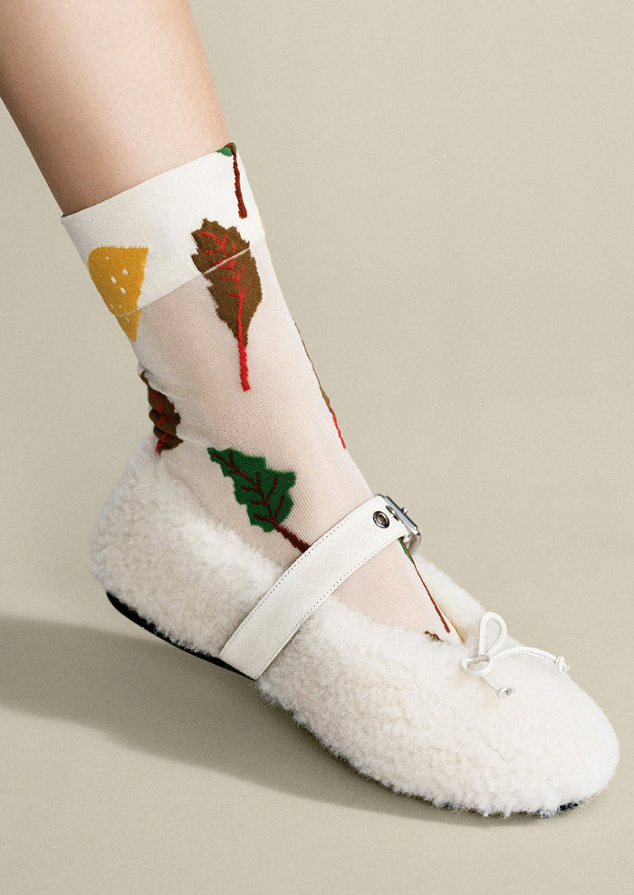 A pair of sheer white nylon socks with swiss chard pattern.